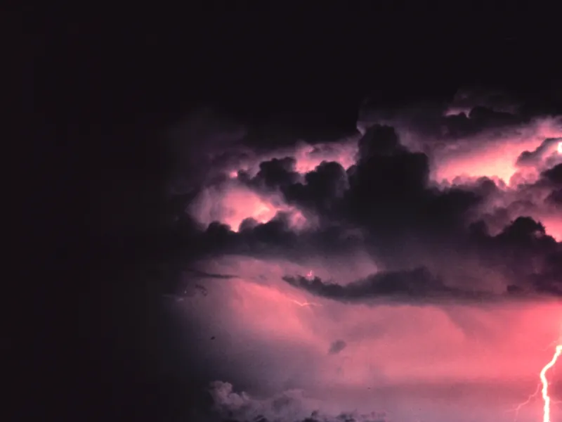 A single bright lightning stroke from a dark cloud to the ground