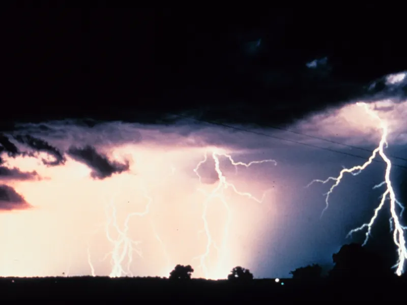 Several bright lightning strokes across a night sky, captured in one long photo